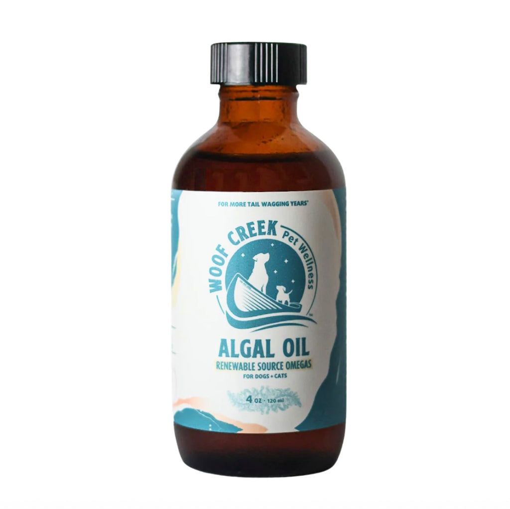 Bottle of Woof Creek Pet Wellness Algal Oil on a white background on a brown glass 4 oz bottle