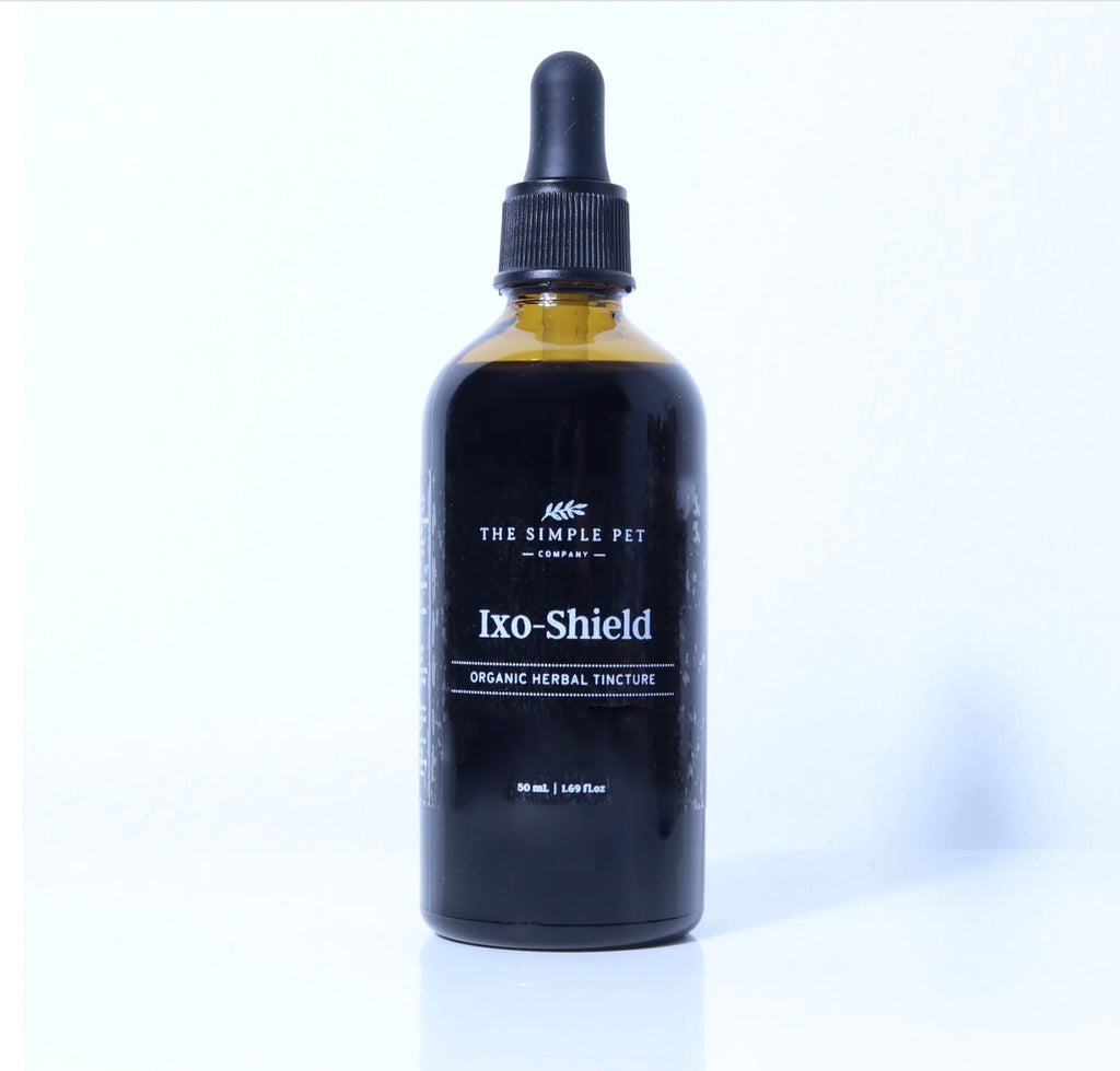 The Simple Pet Black bottle of Ixo-Shield organic herbal tincture with dropper on a white background